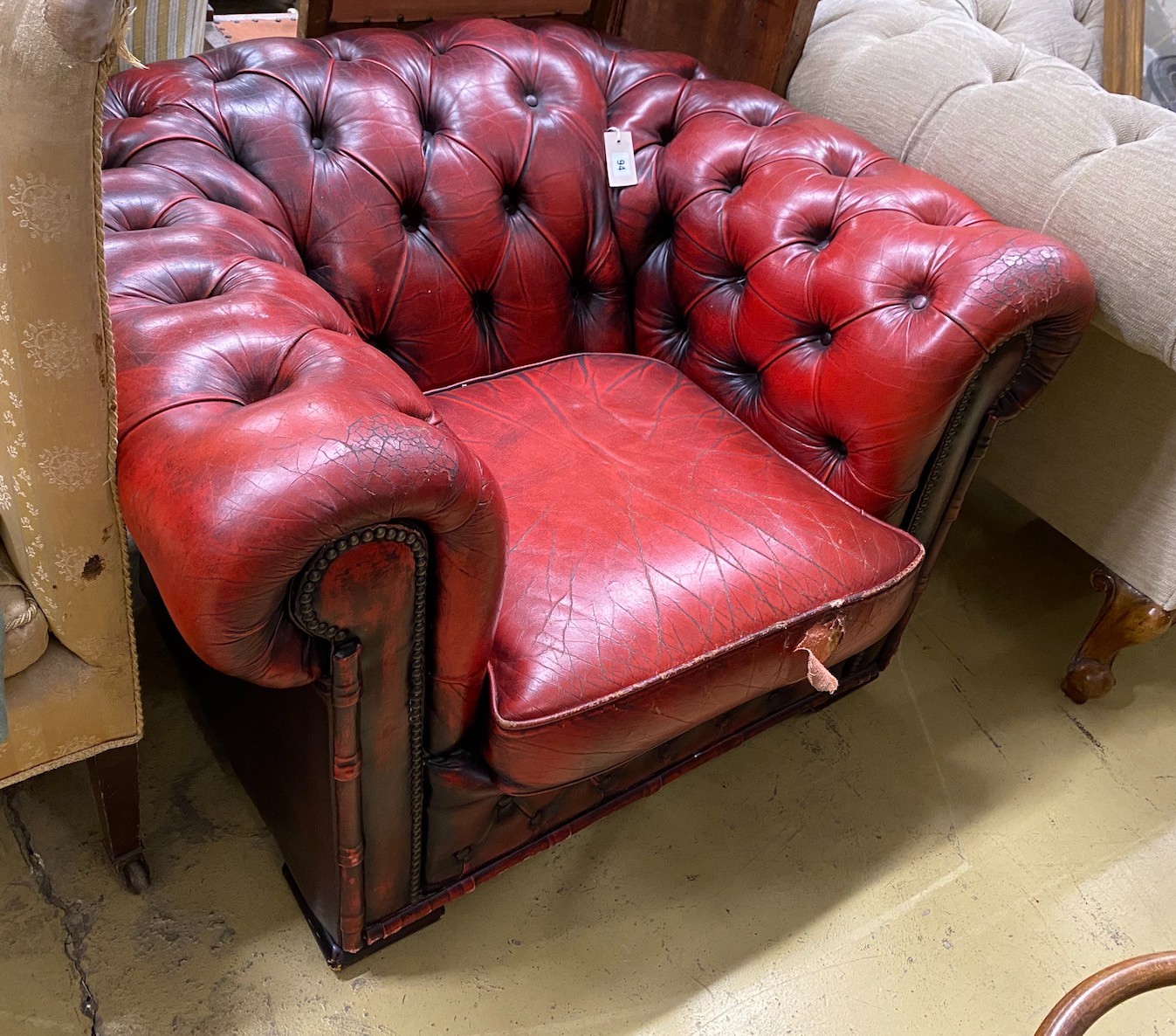 A Victorian style red leather button back Chesterfield armchair, width 104cm, depth 86cm, height 68cm